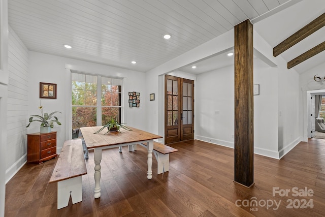 dining space with dark wood-type flooring, french doors, and vaulted ceiling with beams