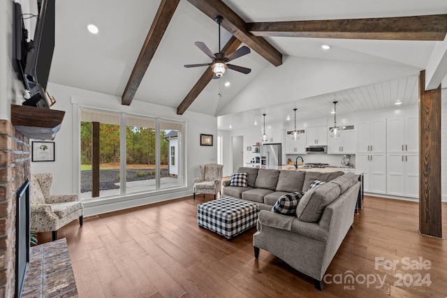 living room with beamed ceiling, hardwood / wood-style flooring, and ceiling fan