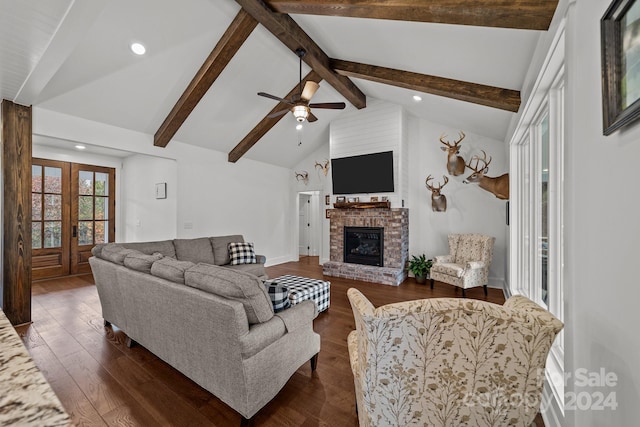 living room featuring a fireplace, beam ceiling, dark hardwood / wood-style flooring, high vaulted ceiling, and ceiling fan