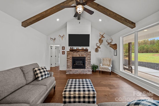 living room with high vaulted ceiling, a brick fireplace, dark wood-type flooring, beamed ceiling, and ceiling fan