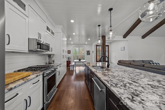 kitchen featuring white cabinetry, sink, light stone counters, and stainless steel appliances