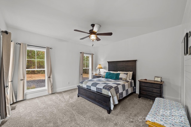 bedroom featuring ceiling fan, multiple windows, and carpet flooring