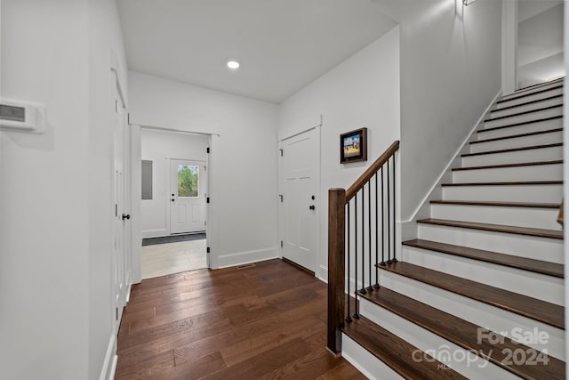 foyer entrance with dark hardwood / wood-style flooring