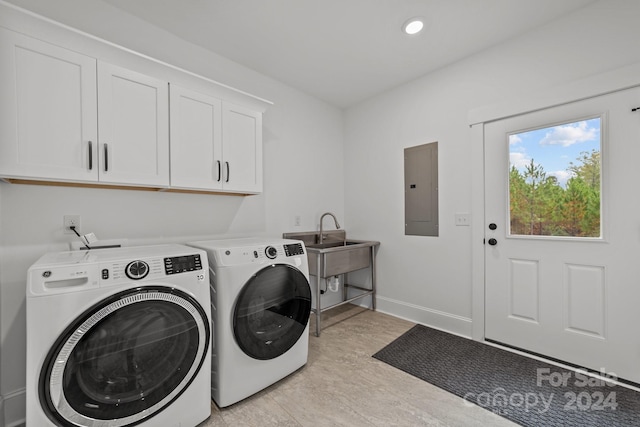 laundry room featuring electric panel, cabinets, and independent washer and dryer