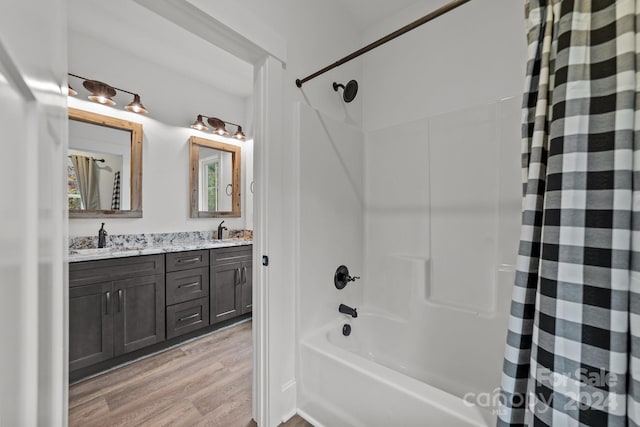 bathroom featuring shower / bath combo with shower curtain, wood-type flooring, and vanity