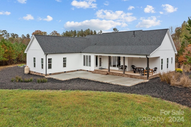 rear view of house featuring a lawn and a patio area