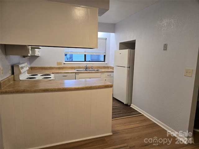 kitchen with white cabinets, white appliances, sink, and dark hardwood / wood-style flooring