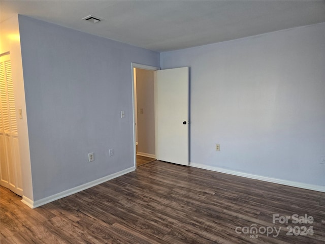 unfurnished room featuring dark hardwood / wood-style flooring