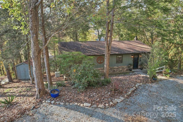 single story home with a storage shed