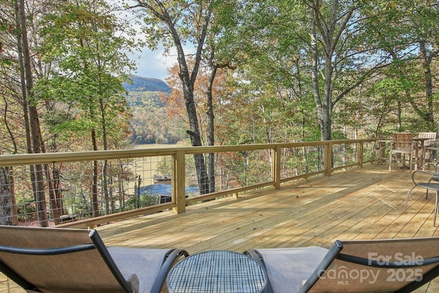 wooden deck with a mountain view