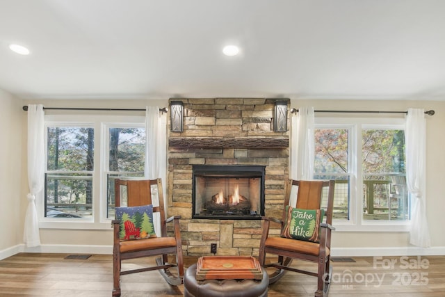 sitting room featuring hardwood / wood-style flooring, plenty of natural light, and a fireplace