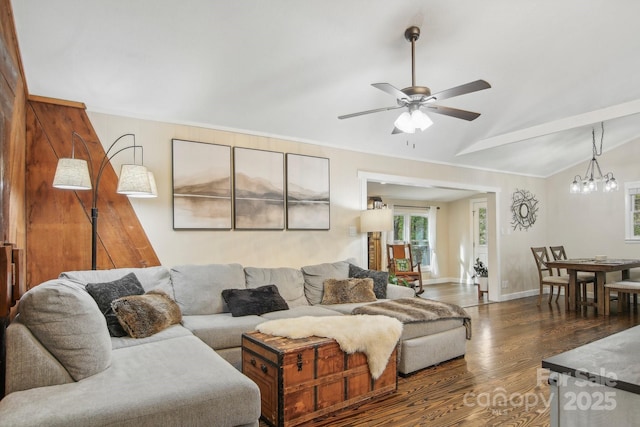 living room with ceiling fan with notable chandelier, dark wood-type flooring, and lofted ceiling