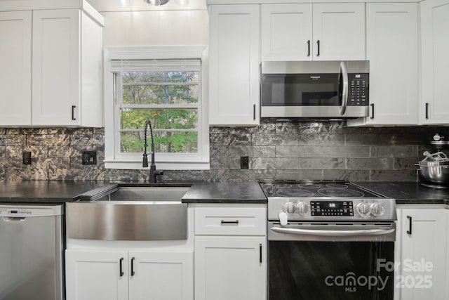 kitchen featuring white cabinets, decorative backsplash, sink, and appliances with stainless steel finishes