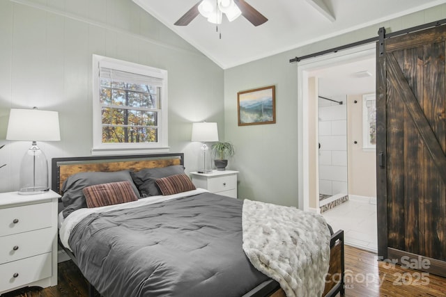 bedroom with ornamental molding, vaulted ceiling, ceiling fan, dark wood-type flooring, and a barn door