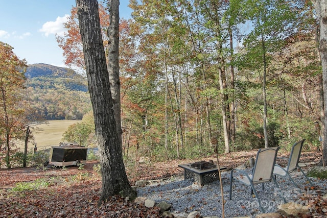 view of yard with a mountain view and a fire pit