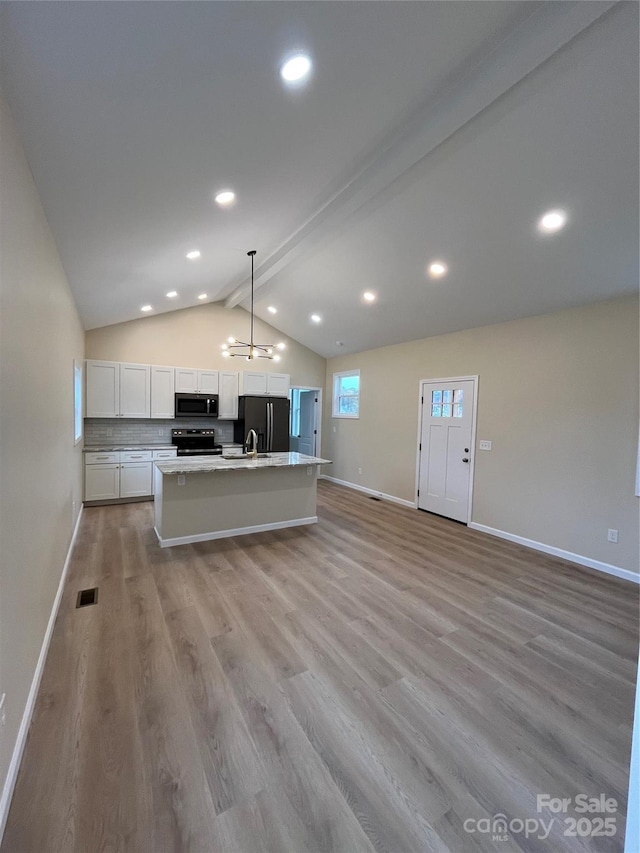 kitchen with black fridge with ice dispenser, range with electric stovetop, an island with sink, pendant lighting, and white cabinets