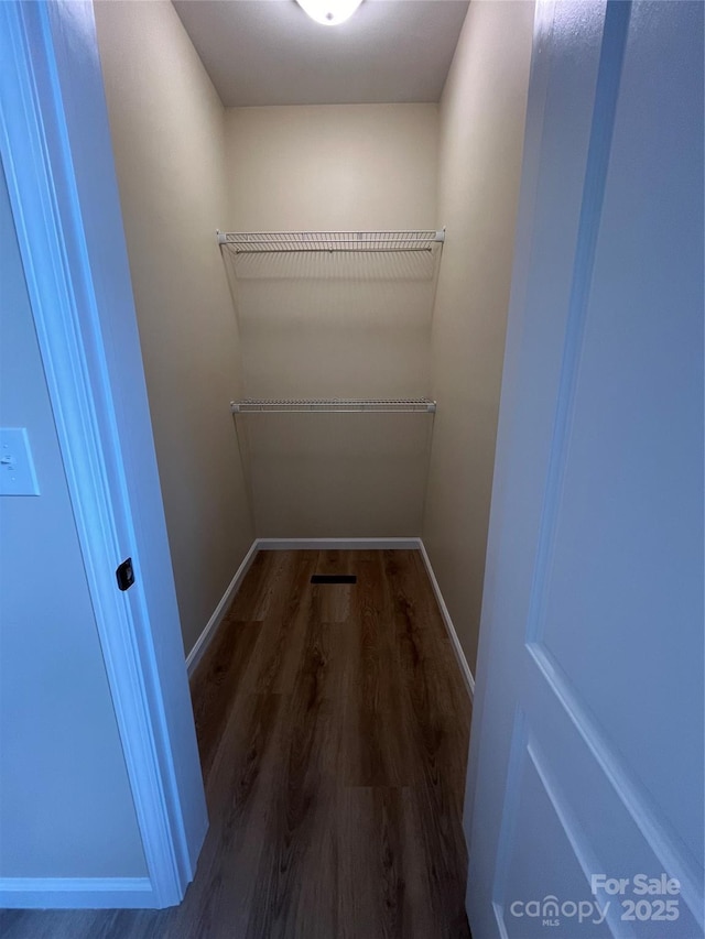 walk in closet featuring dark hardwood / wood-style floors