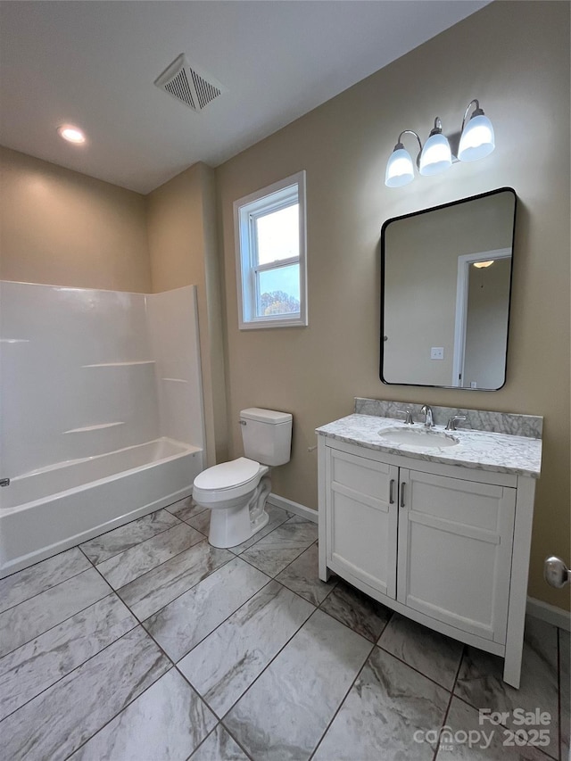 full bathroom featuring washtub / shower combination, vanity, and toilet