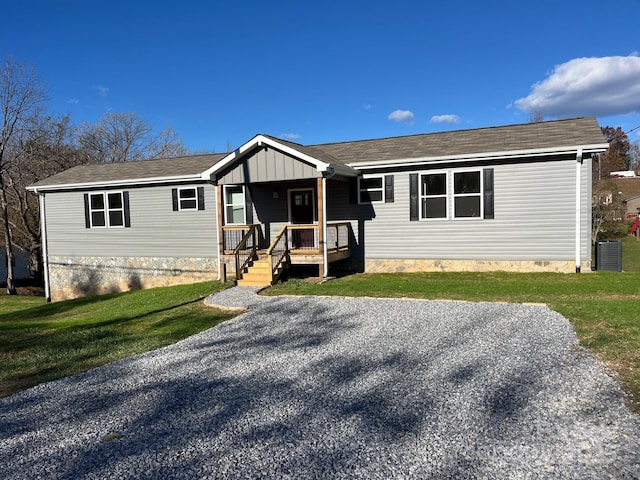 single story home featuring crawl space, covered porch, central air condition unit, and a front lawn