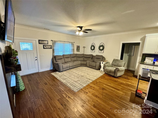 living room featuring ornamental molding, a wealth of natural light, and dark hardwood / wood-style flooring