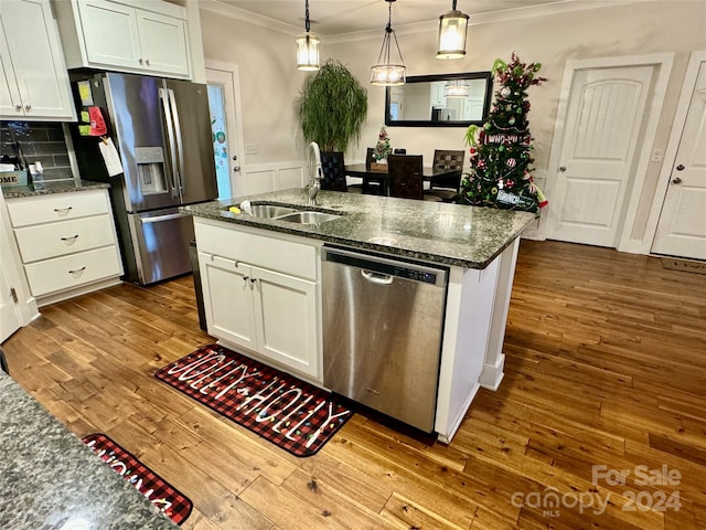 kitchen featuring dark stone counters, white cabinetry, appliances with stainless steel finishes, and sink