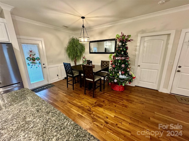 dining space featuring dark hardwood / wood-style floors and ornamental molding