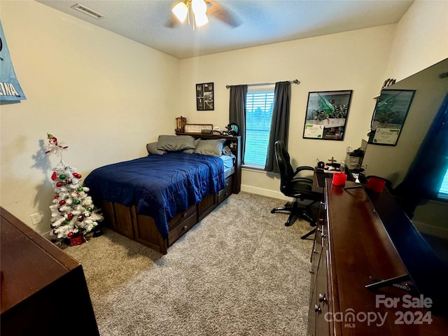 bedroom with ceiling fan and light carpet