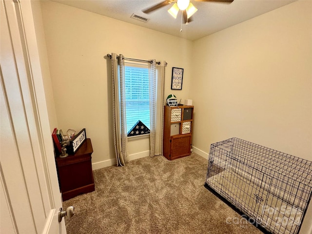 living area with carpet floors and ceiling fan