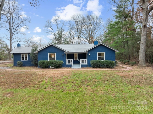 ranch-style home featuring a porch and a front lawn