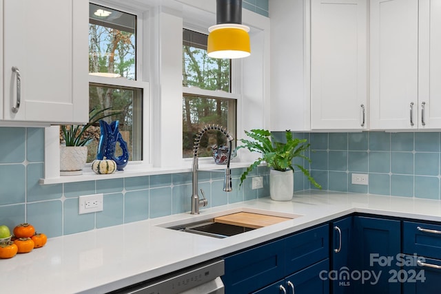 kitchen featuring backsplash, white cabinetry, and sink