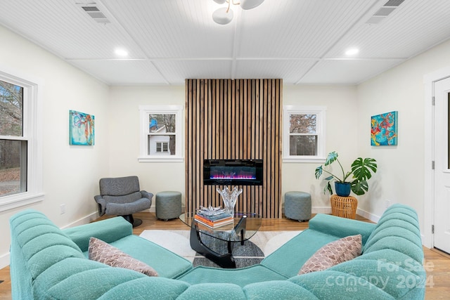 living room featuring light hardwood / wood-style floors and ceiling fan