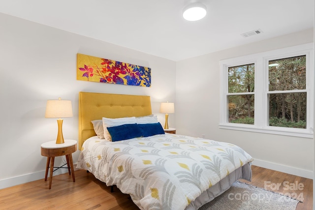 bedroom with hardwood / wood-style flooring