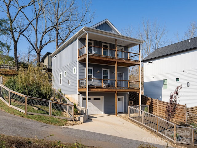 view of front facade with a garage and a balcony