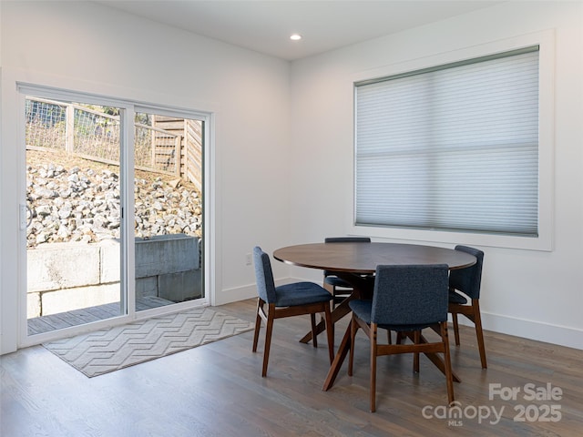 dining space featuring recessed lighting, baseboards, and wood finished floors