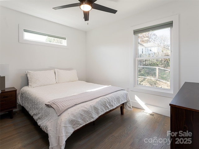 bedroom featuring ceiling fan, dark wood-style flooring, and visible vents