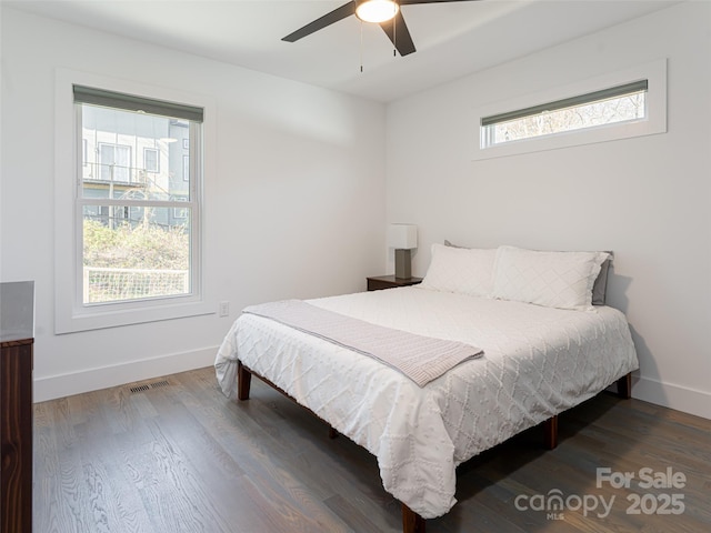 bedroom featuring visible vents, wood finished floors, a ceiling fan, and baseboards