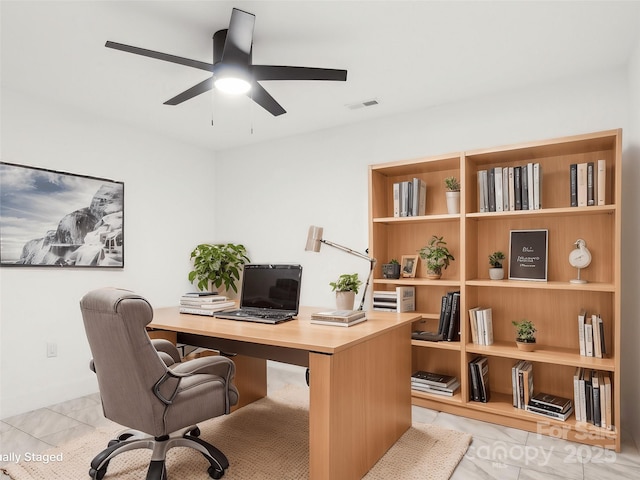 office space featuring visible vents and ceiling fan