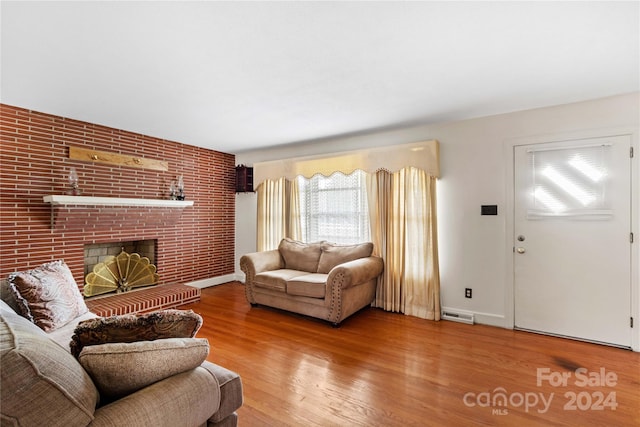 living room featuring a fireplace and hardwood / wood-style flooring