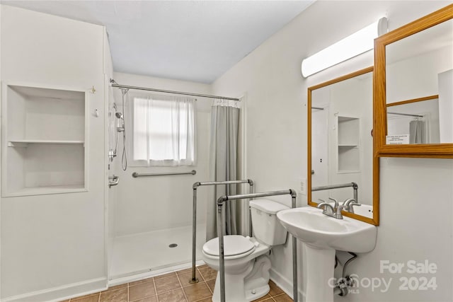 bathroom with toilet, a shower with shower curtain, and tile patterned floors