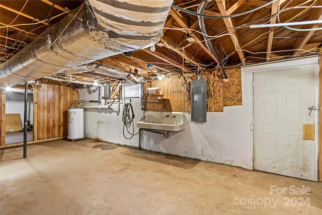 basement featuring electric panel, water heater, and sink