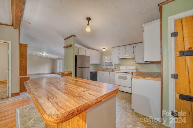 kitchen featuring dishwasher, white electric range oven, stainless steel fridge, vaulted ceiling, and white cabinets