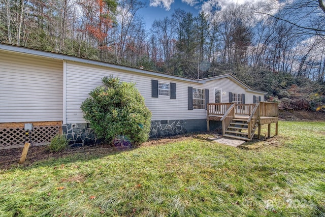 view of front of house featuring a front lawn and a wooden deck