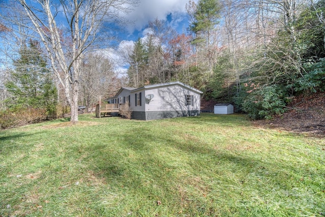 view of yard with a shed and a wooden deck