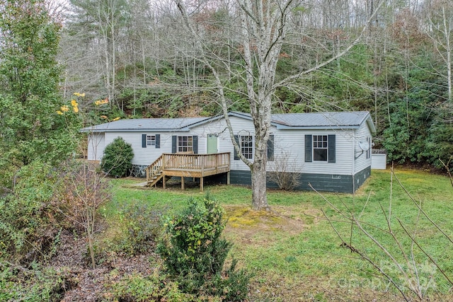 back of property featuring a lawn and a deck