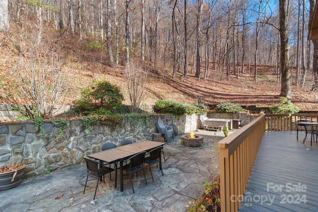 view of patio featuring an outdoor fire pit and a wooden deck