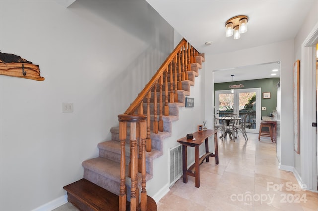 stairs featuring tile patterned flooring