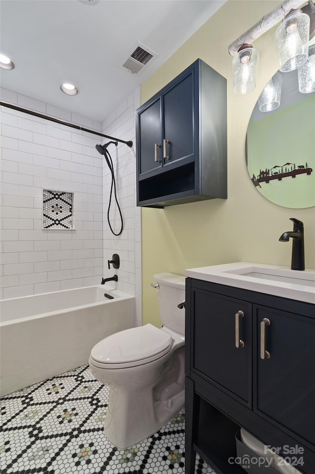 full bathroom featuring tile patterned floors, vanity, toilet, and tiled shower / bath