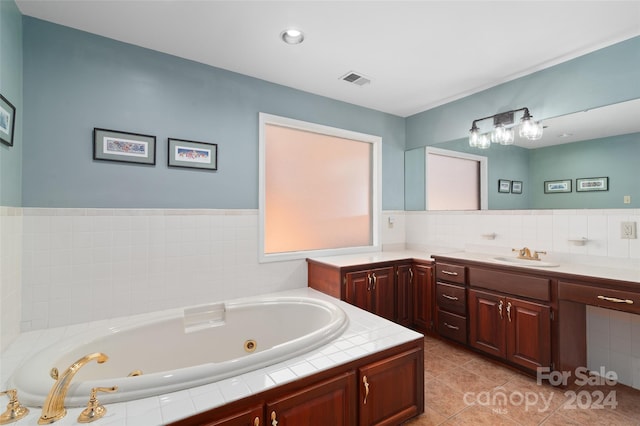 bathroom with tile patterned flooring, vanity, and a tub to relax in