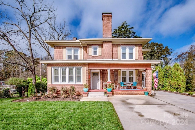 view of front of house featuring a front lawn and covered porch