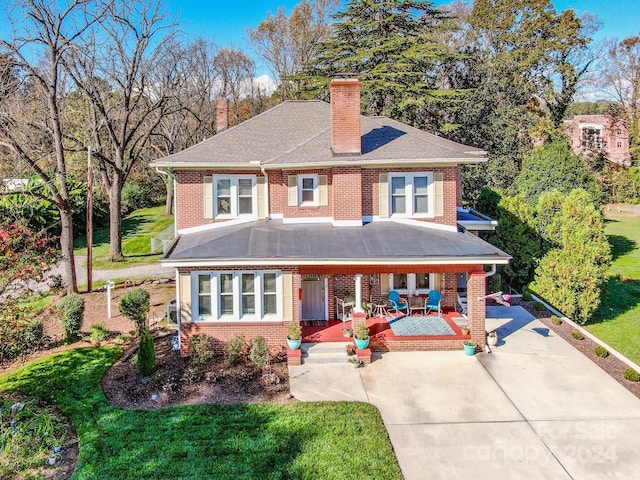 view of front of property with covered porch and a front yard